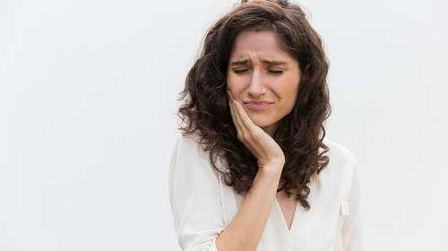 A woman in pain before getting a modern root canal therapy in Pampa, TX