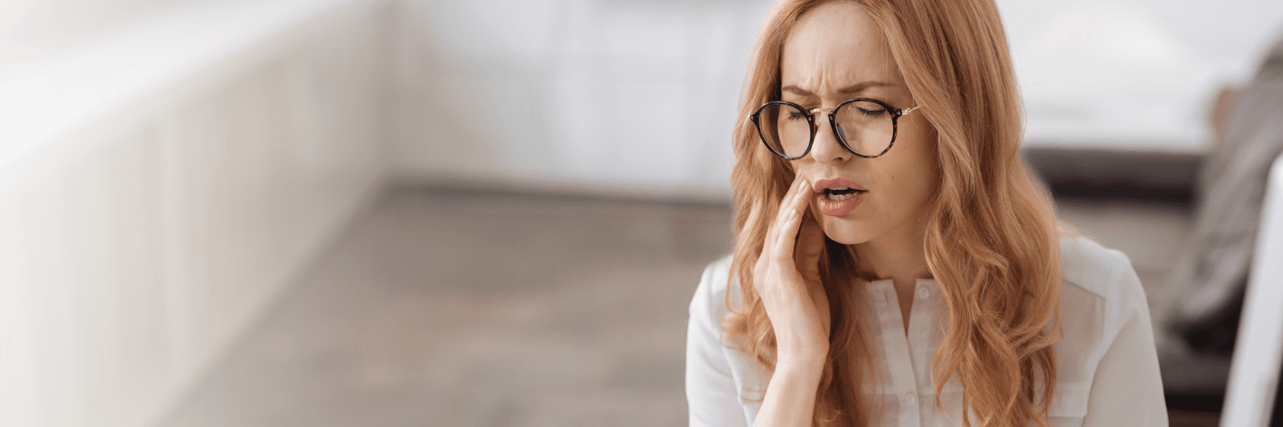 A woman in pain having an emergency dental problem in Pampa, TX