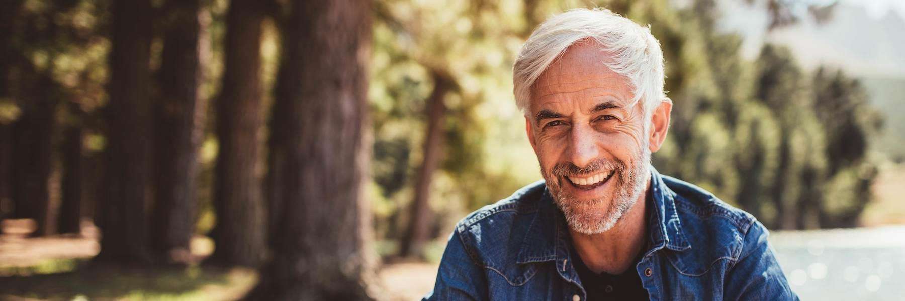 An old man smiling after getting Dental Implants in Pampa, TX